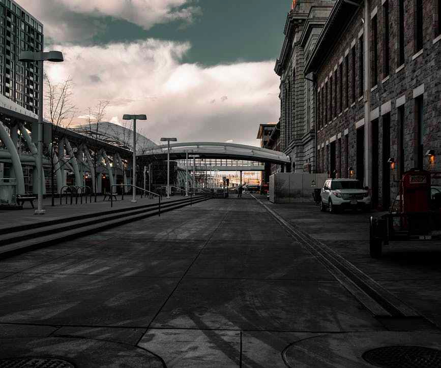 an empty street under cloudy sky