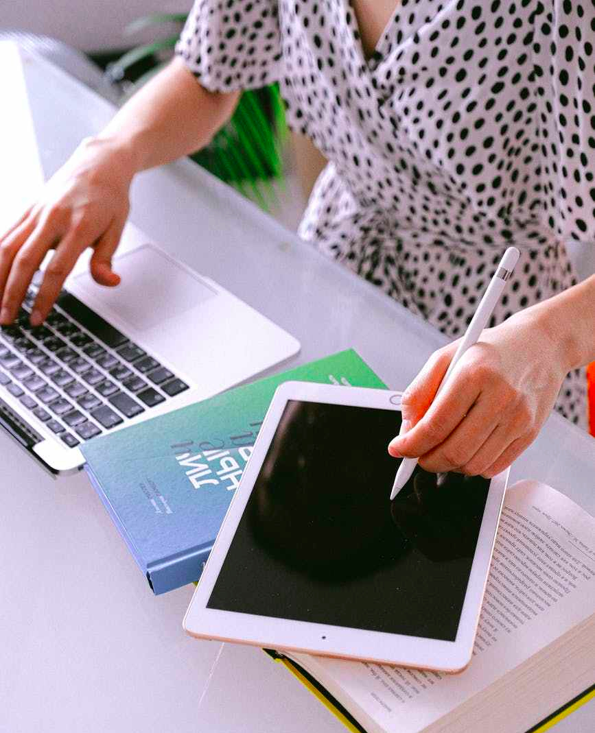 person using laptop and tablet