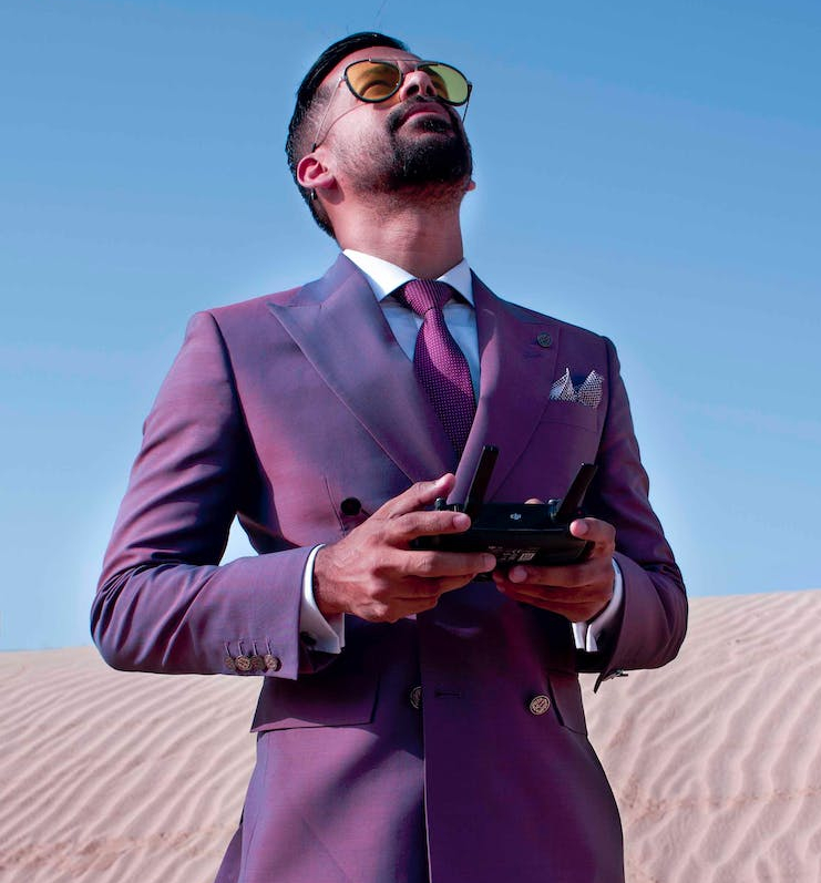 photo of man holding remote control while looking upwards