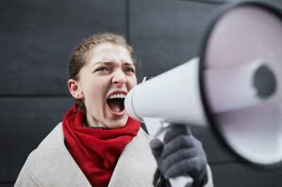 a woman in red scarf holding a megaphone